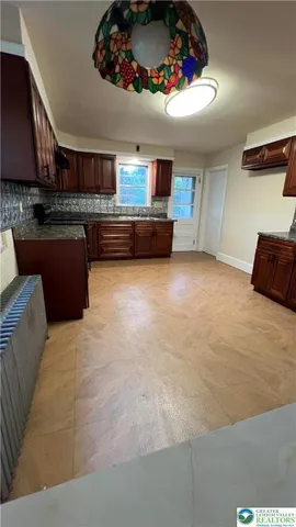 a kitchen with granite countertop a sink and a stove