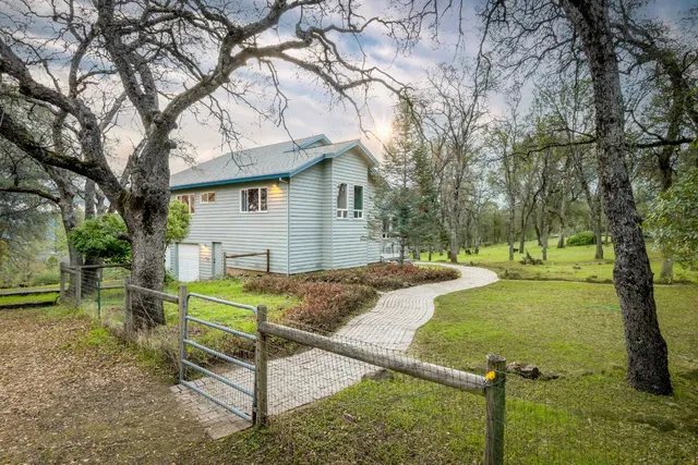 a living room with fireplace furniture and a large window
