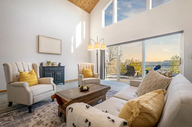 a view of a dining room with furniture large windows and wooden floor