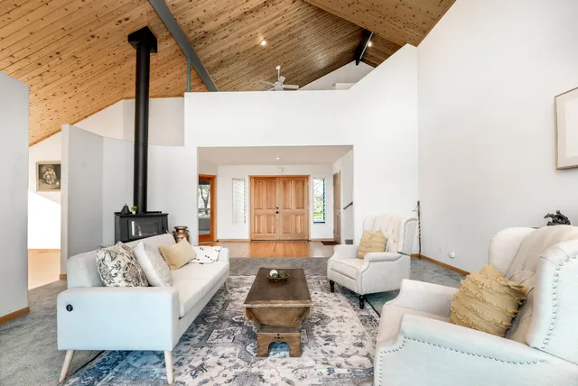 a large kitchen with stainless steel appliances granite countertop a large stove top oven a sink dishwasher and wooden cabinets with wooden floor