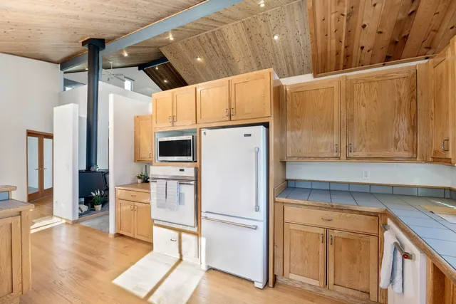 a bathroom with a double vanity sink toilet mirror and shower