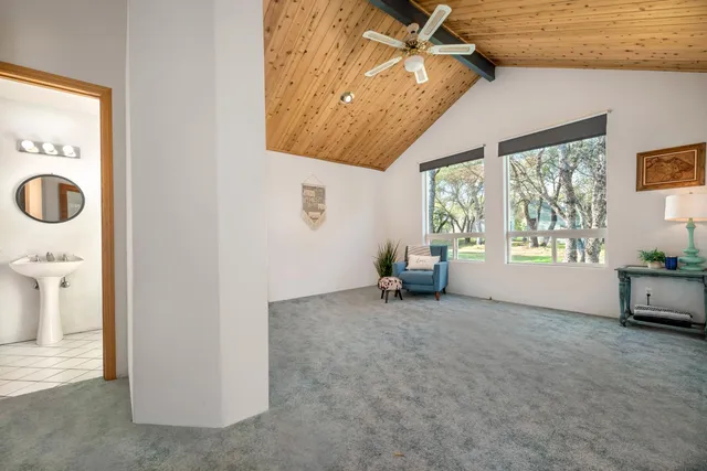 a bathroom with a double vanity sink a mirror and a bathtub