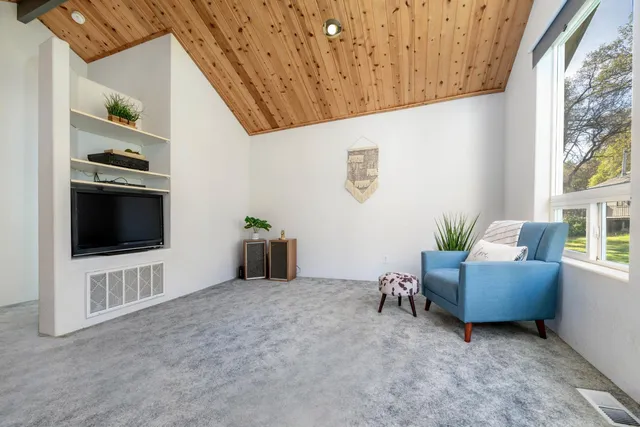 a view of a roof deck with wooden floor and seating space