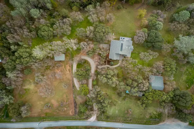a balcony with wooden floor table and chairs