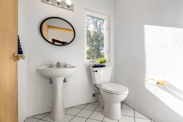 a backyard of a house with lots of green space and fountain