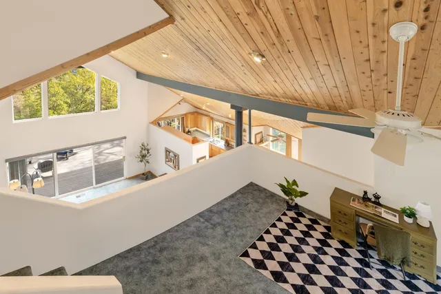 a view of a house with a small yard and wooden fence