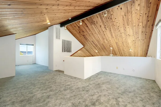 a view of a kitchen with flat screen tv and window
