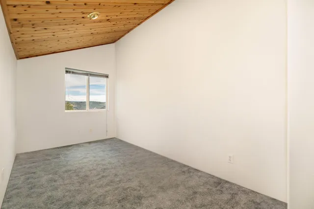a large white kitchen with granite countertop a stove and a sink