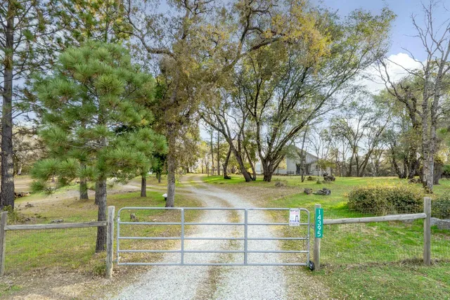a view of a house with swimming pool and a yard