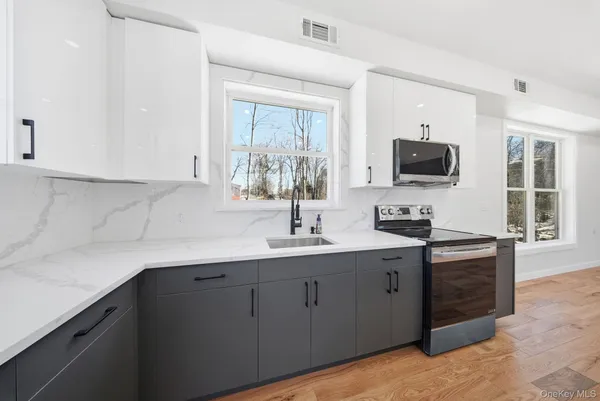 a kitchen with cabinets a sink and appliances