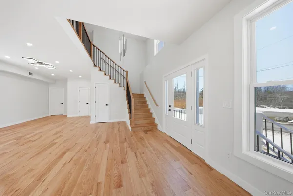 a view of entryway with wooden floor and stairs
