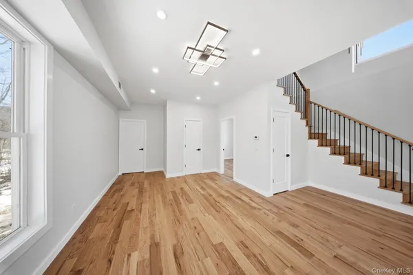 a view of a room with wooden floor and staircase