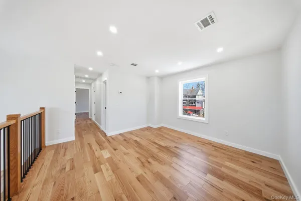 a view of hallway with wooden floor