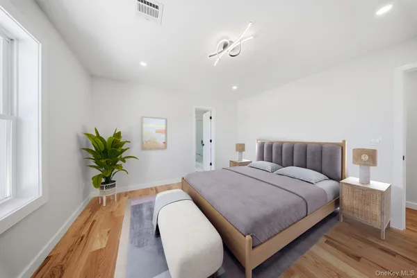 a bedroom with a bed and a potted plant