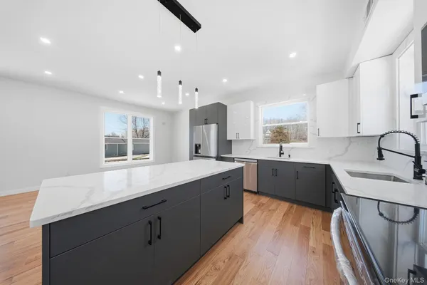 a kitchen with a sink appliances and cabinets