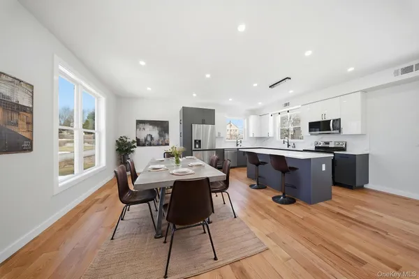 a large kitchen with a table and chairs