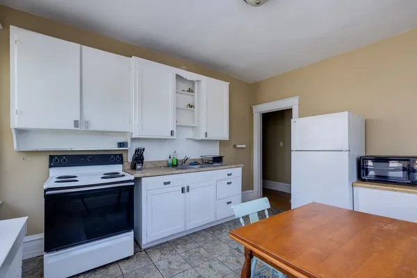 a kitchen with stainless steel appliances granite countertop a stove a refrigerator and a cabinets