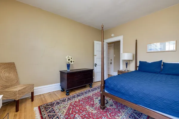 a bedroom with a bed and a chair