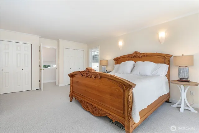 a spacious bedroom with a bed and a lamp