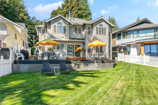 a front view of a house with swimming pool and chairs