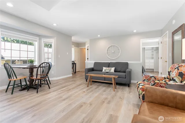 a living room with furniture and a wooden floor