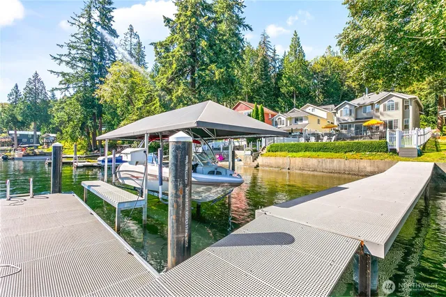 a view of a patio with chairs under an umbrella