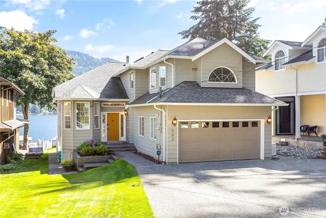 a view of a house with a yard and balcony