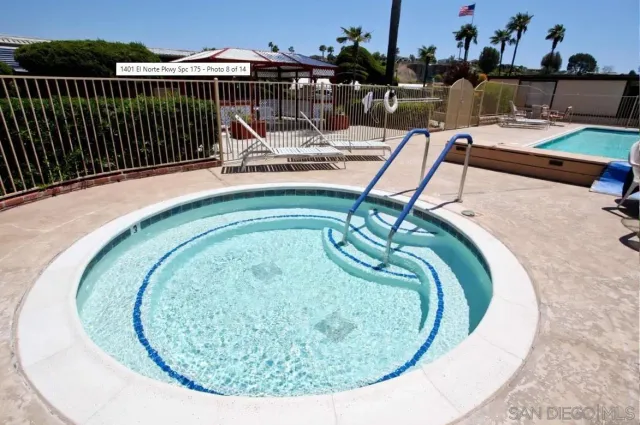 a kitchen with kitchen island a dining table chairs stainless steel appliances and cabinets
