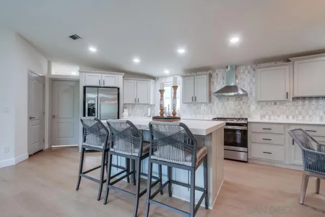 a view of a patio with table and chairs under an umbrella