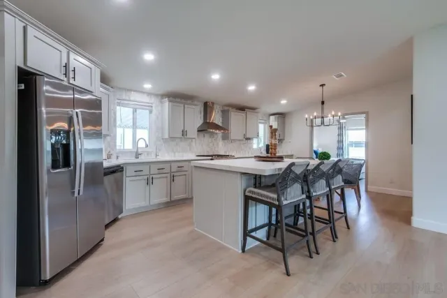 a kitchen with a sink stove cabinets and chairs