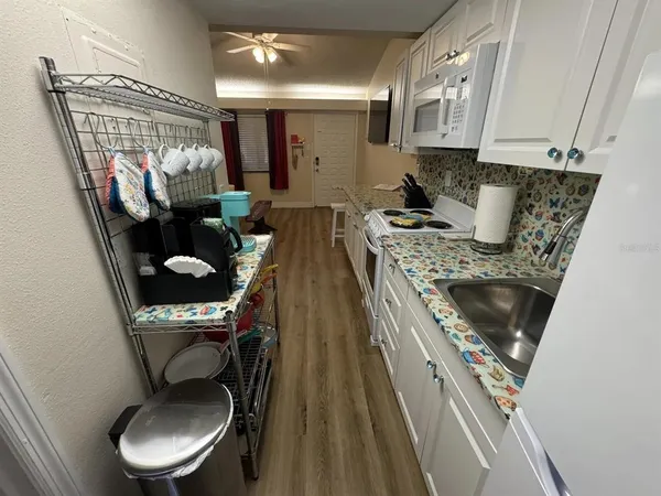 a kitchen with a table chairs stove and cabinets