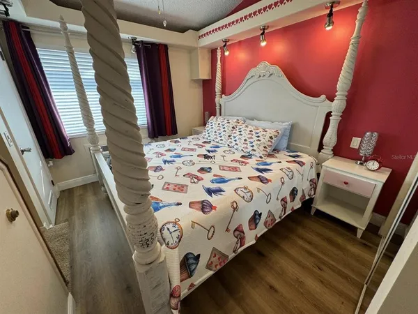 a bed sitting in a bedroom next to a window
