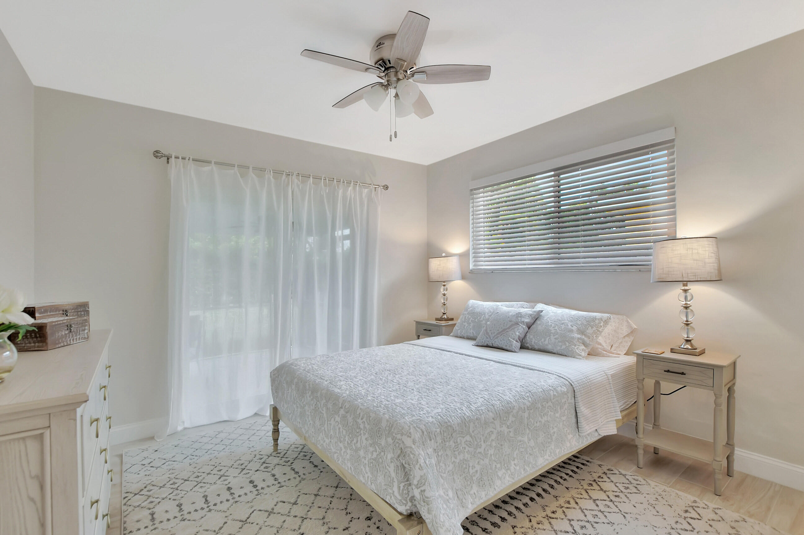 1133 Southwest 7th Street Boca Raton, FL 33486 - Photo 13 of 20 a bedroom with a bed and a chandelier