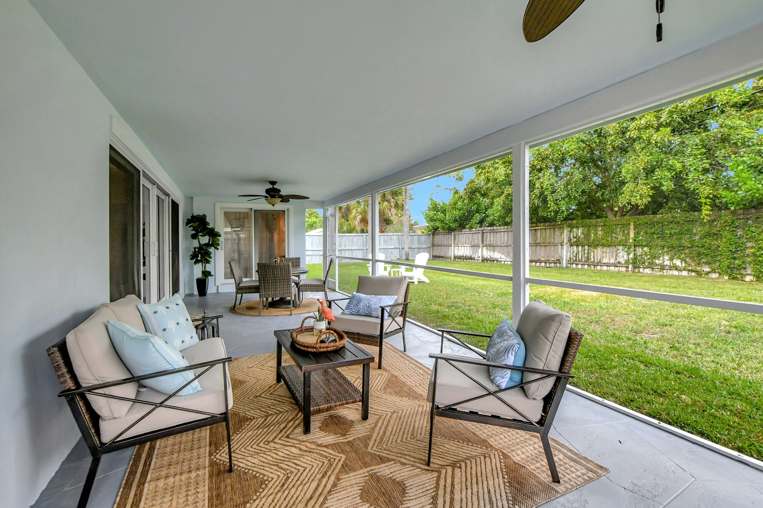 1133 Southwest 7th Street Boca Raton, FL 33486 - Photo 3 of 20 a patio with yard glass top table and chairs