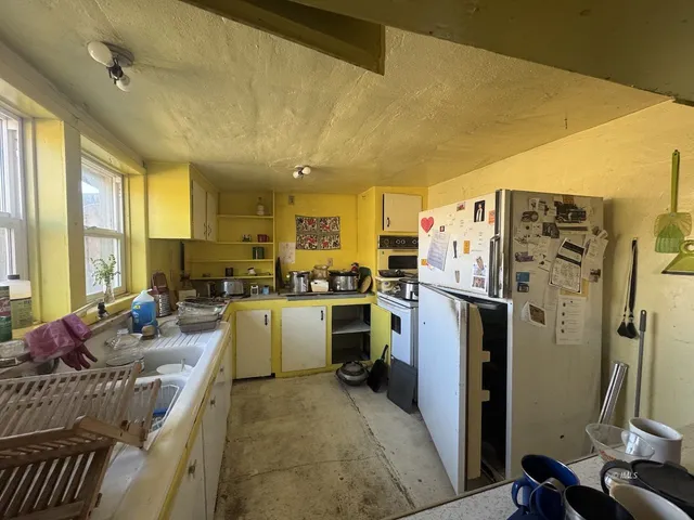 a kitchen with sink refrigerator and window