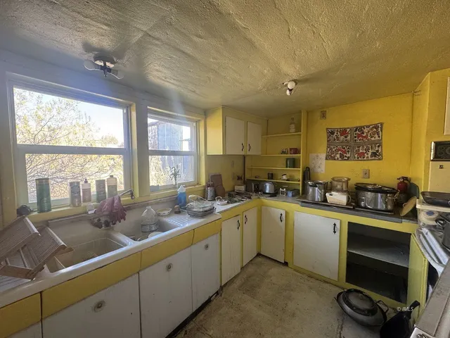 a kitchen with a sink stove and cabinets