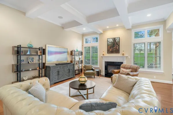 a living room with furniture fireplace and flat screen tv