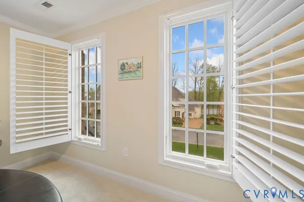 a view of a bedroom with a window and balcony