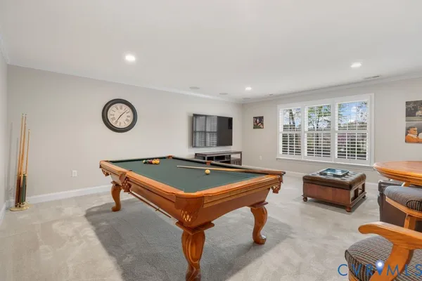 a room with furniture pool table and flat screen tv