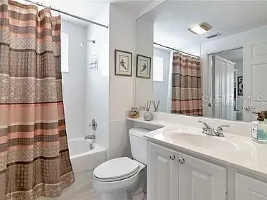 a bathroom with a sink toilet vanity and shower
