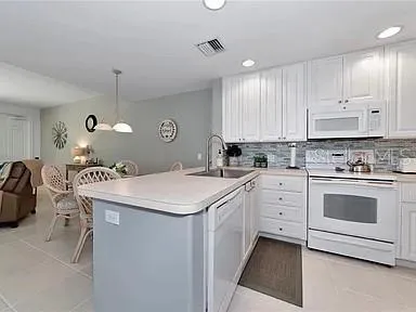 a kitchen with cabinets appliances and a counter top space