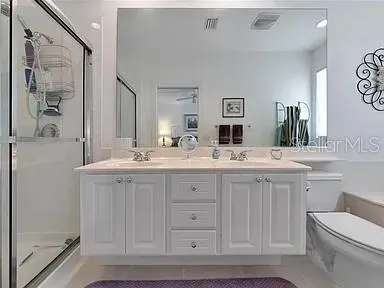 a bathroom with a double vanity sink and a mirror
