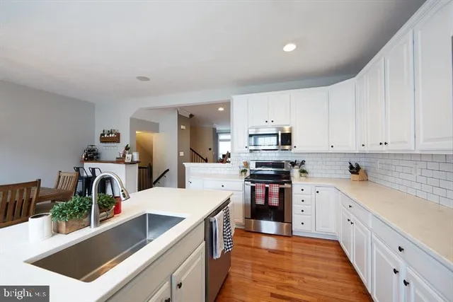 a large kitchen with stainless steel appliances lots of counter top space cabinets and a center island