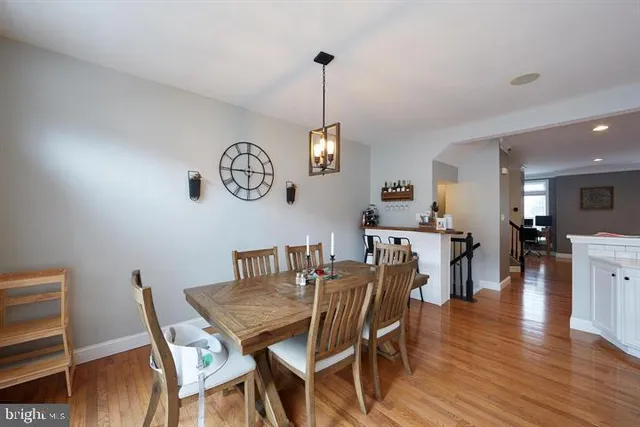 a view of a dining room with furniture wooden floor and a chandelier
