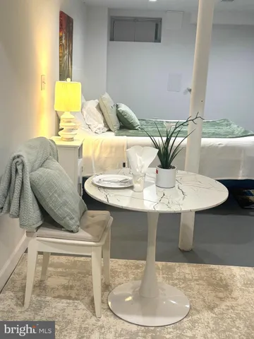 a dining room with furniture and wooden floor