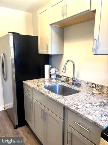 a kitchen with a sink and a refrigerator