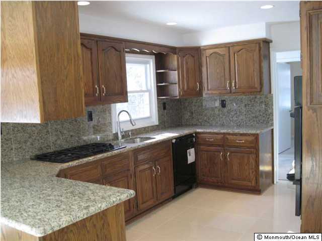 178 Van Brackle Road Matawan, NJ 07747 - Photo 2 of 3 a kitchen with stainless steel appliances granite countertop a sink stove and cabinets