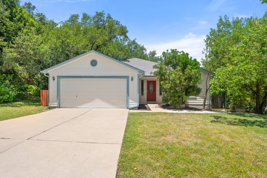 5208 Sioux Lane Austin, TX 78734 - Photo 1 of 35 A well-maintained facade with a prominent garage and inviting entry.
