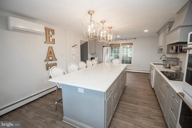 a large white kitchen with stainless steel appliances