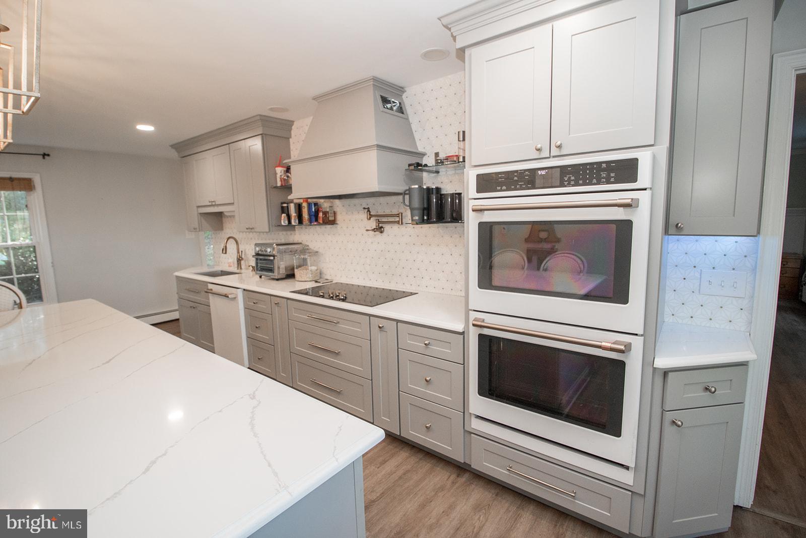 8120 Chapel Point Road Port Tobacco, MD 20677 - Photo 12 of 95 a kitchen with a stove oven and white cabinets
